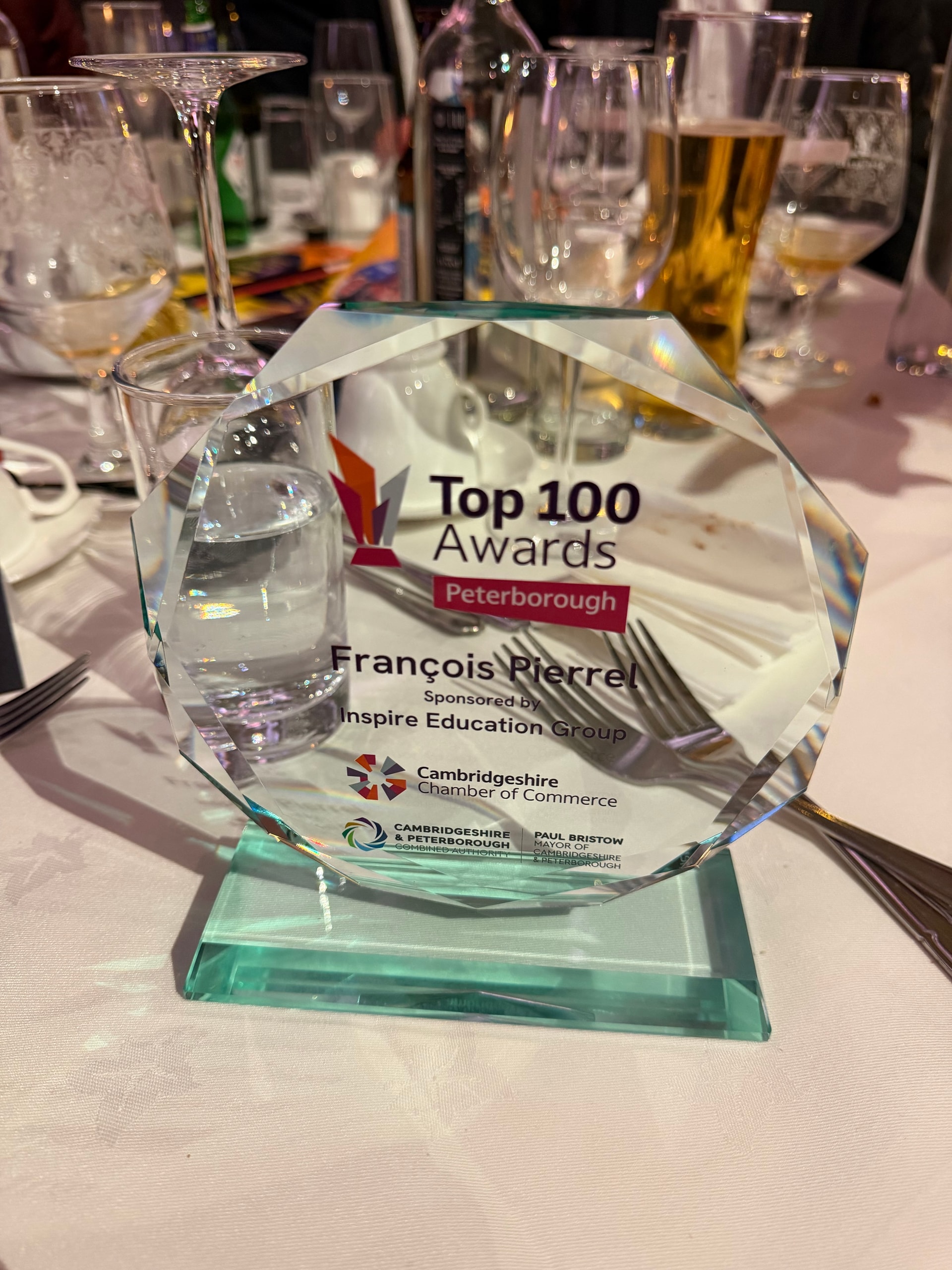 Glass Top 100 Awards trophy for François Pierrel on a dinner table