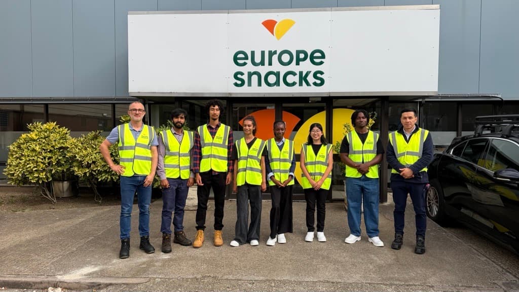 Placement students and EnerTherm engineers in hi-vis outside a Europe Snacks factory during a site visit