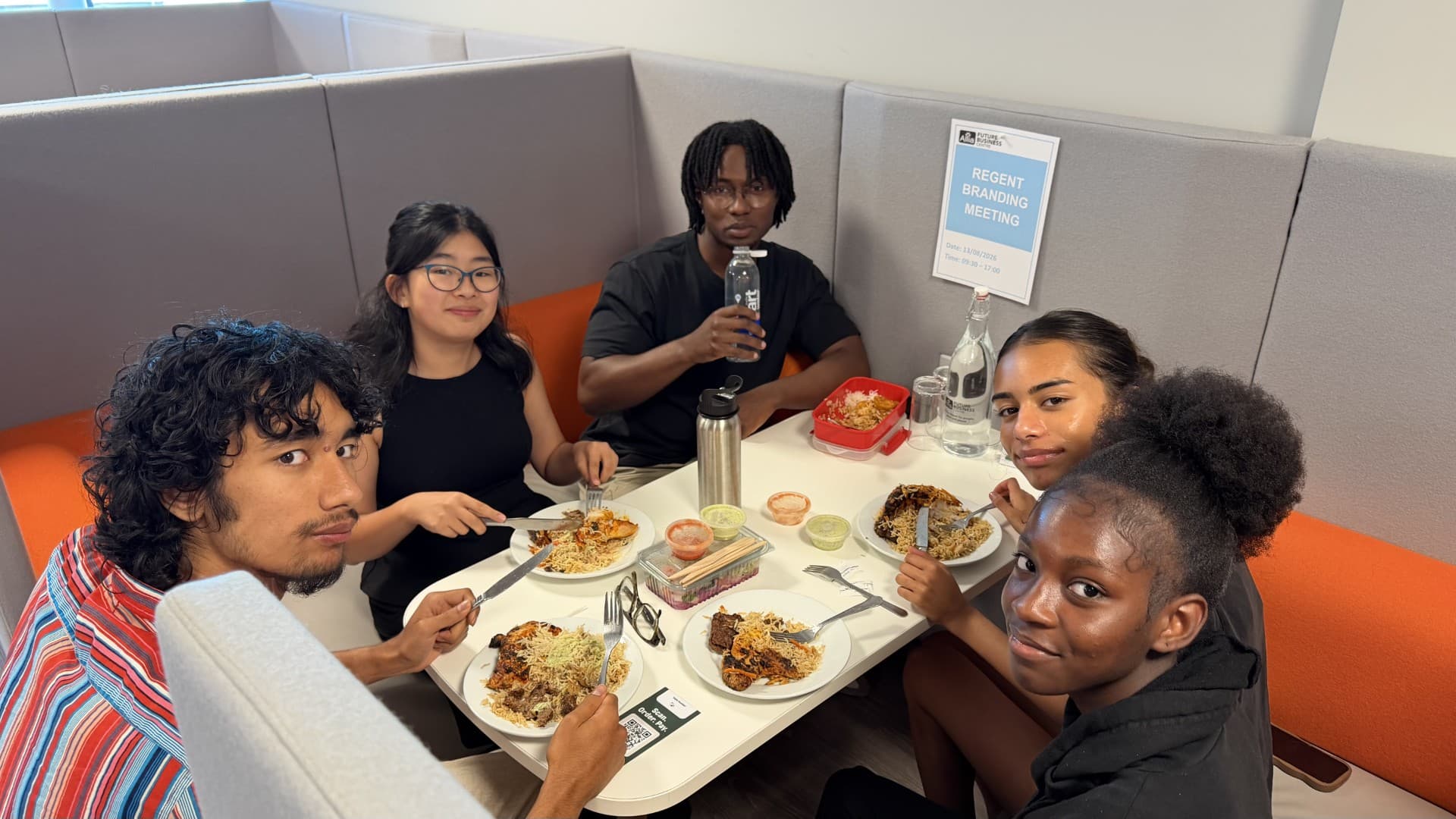 Placement students sitting round a table over lunch at the Future Business Centre in Peterborough